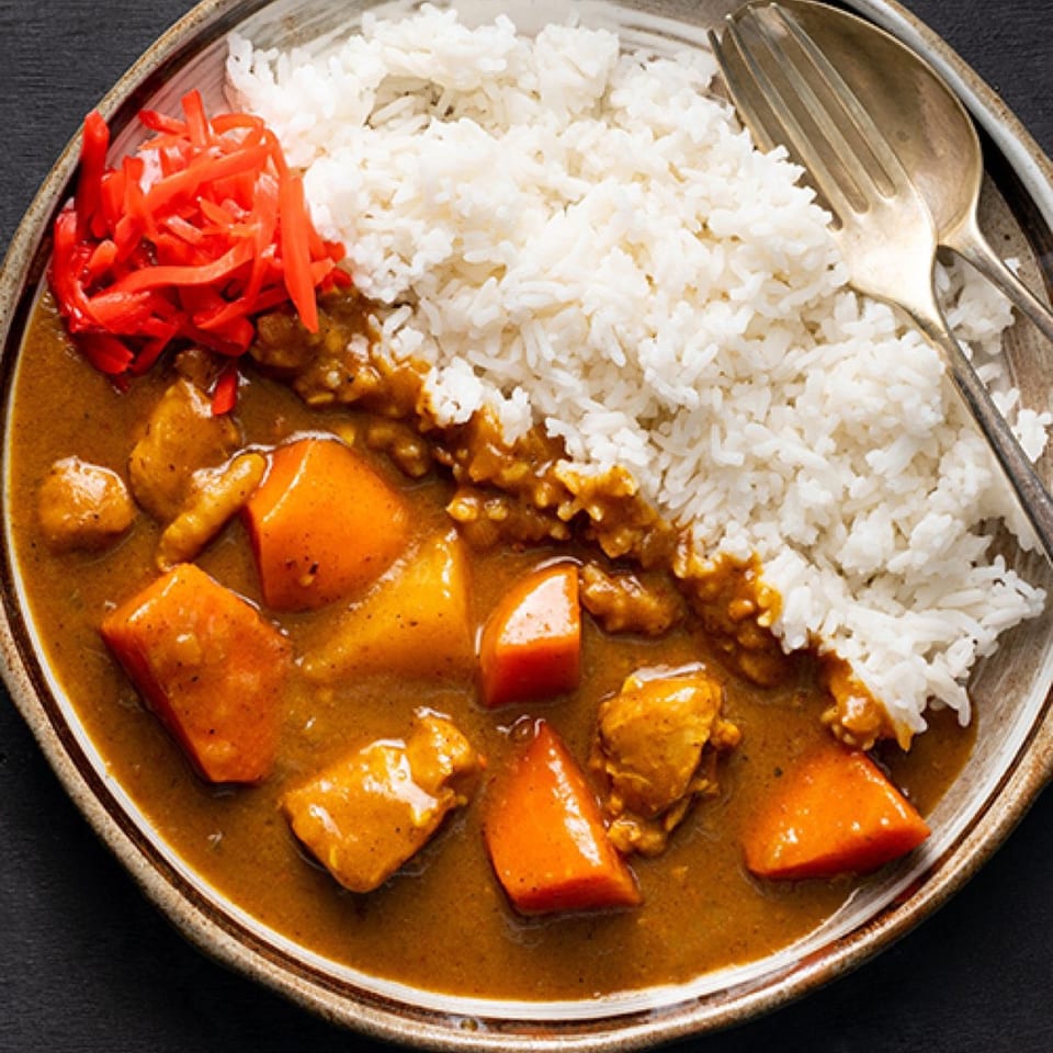 Donburiya Cafe's Japanese curry with rice, chicken, carrots, and red pickled ginger.