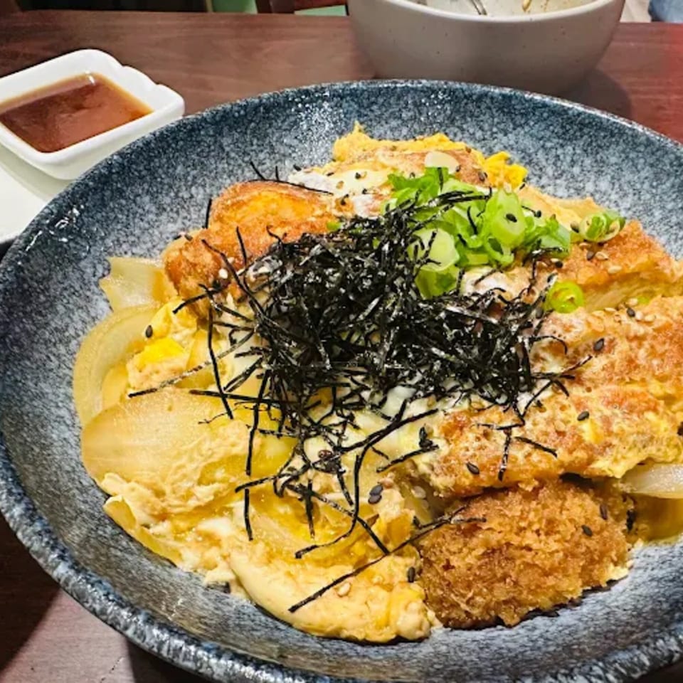 Donburiya Cafe's katsudon, a Japanese dish with fried pork cutlet, egg, onions, and seaweed.